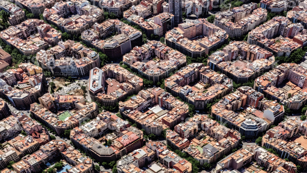 Aerial view of Barcelona showing its clear grid layout and chamfered street corners in the Eixample district.